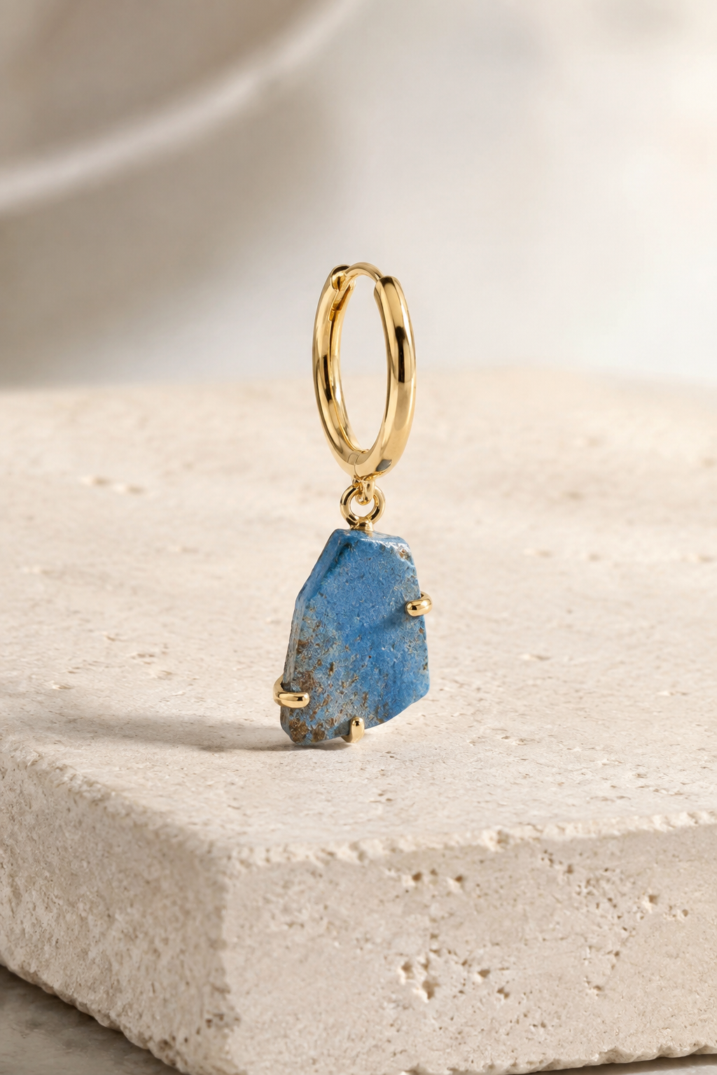 Egyptian faience fragment set in a contemporary gold earring