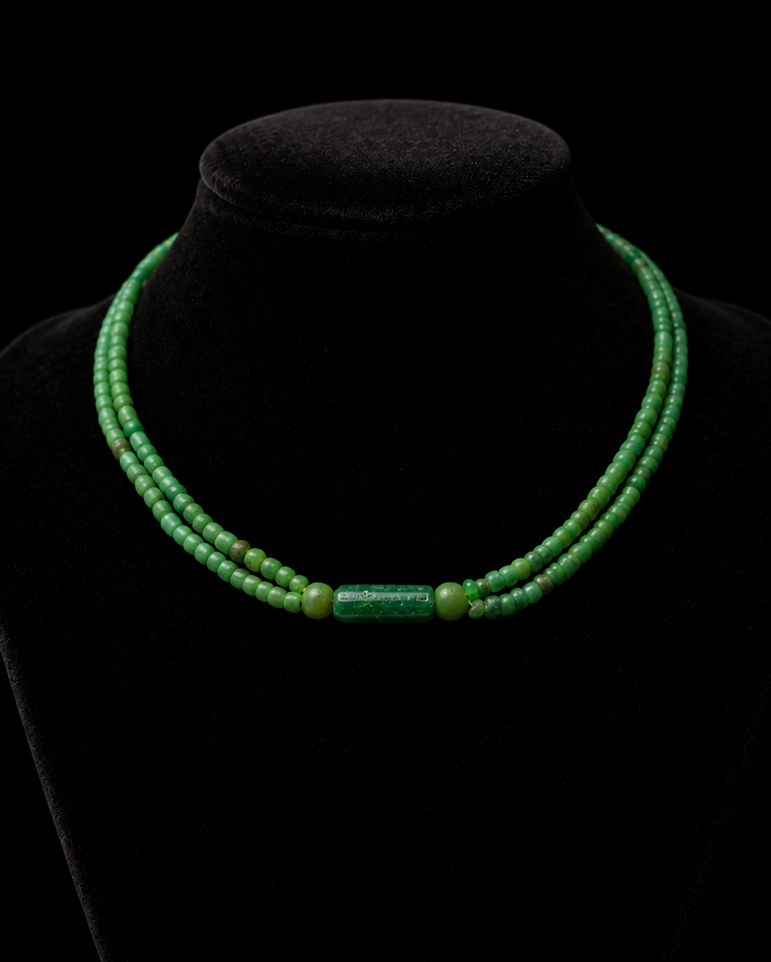 Roman necklace photographed close on a black velvet bust