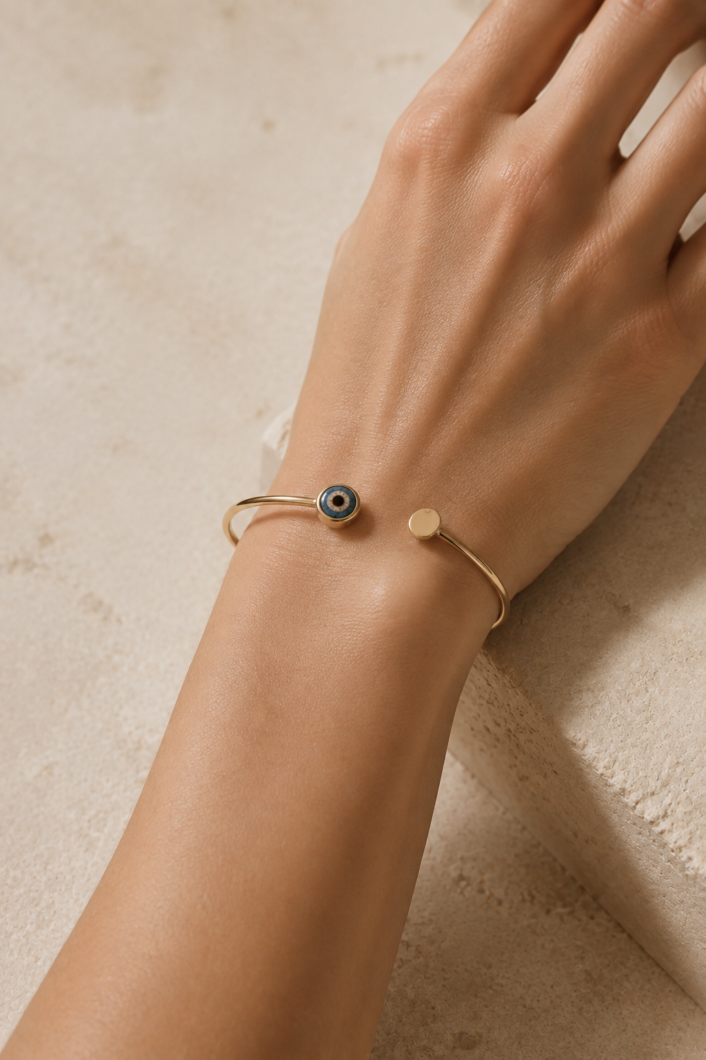 Phoenician glass eye-bead cuff worn at the wrist