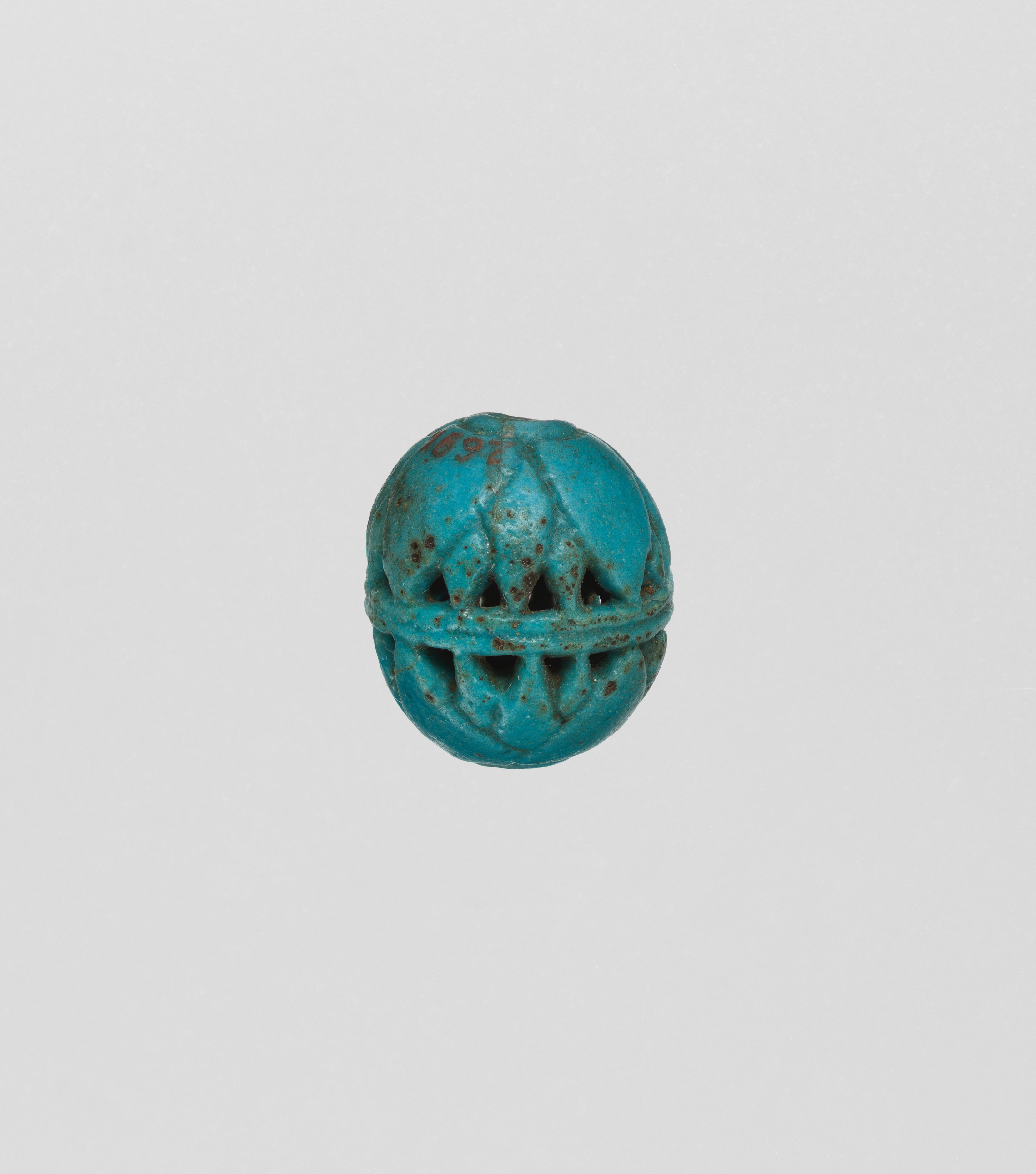 Turquoise Egyptian faience bead with openwork design in the Metropolitan Museum of Art