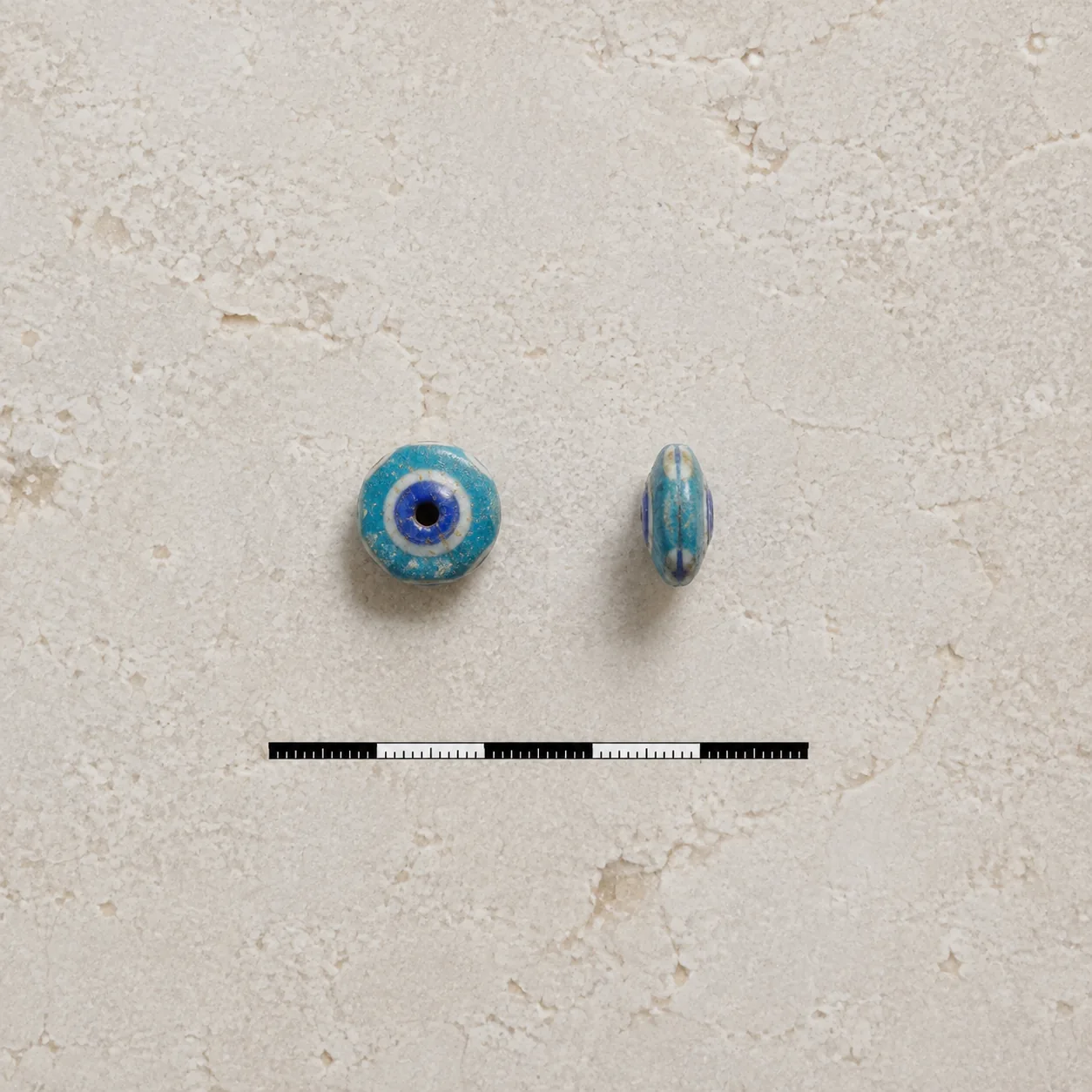 Photographic material reference of a Phoenician glass eye bead, front and profile